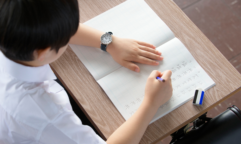 Photo of an elementary school student practicing kanji with the Seiko School Time watch