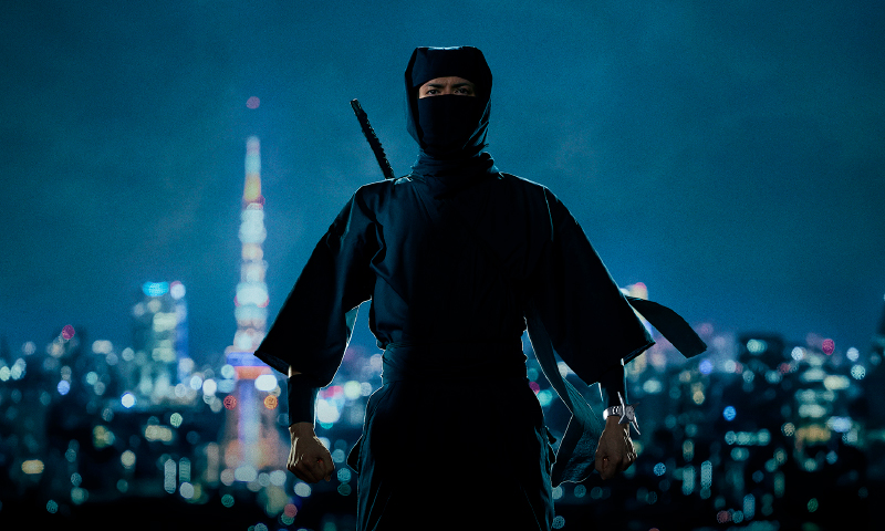 Photo of a ninja with a night view in the background