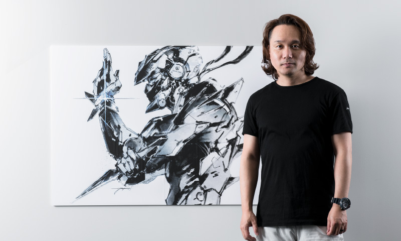 Photo of Yoji Shinkawa and the illustration board