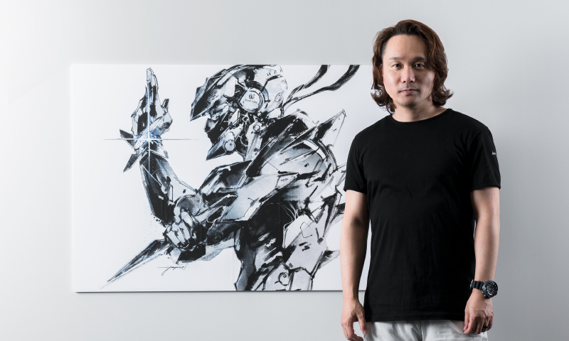 Photo of Yoji Shinkawa and the illustration board