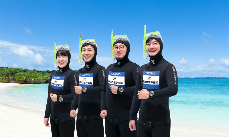 Photo of Koriyama, Sakai, Hibayashi, and Yoshida in wetsuits