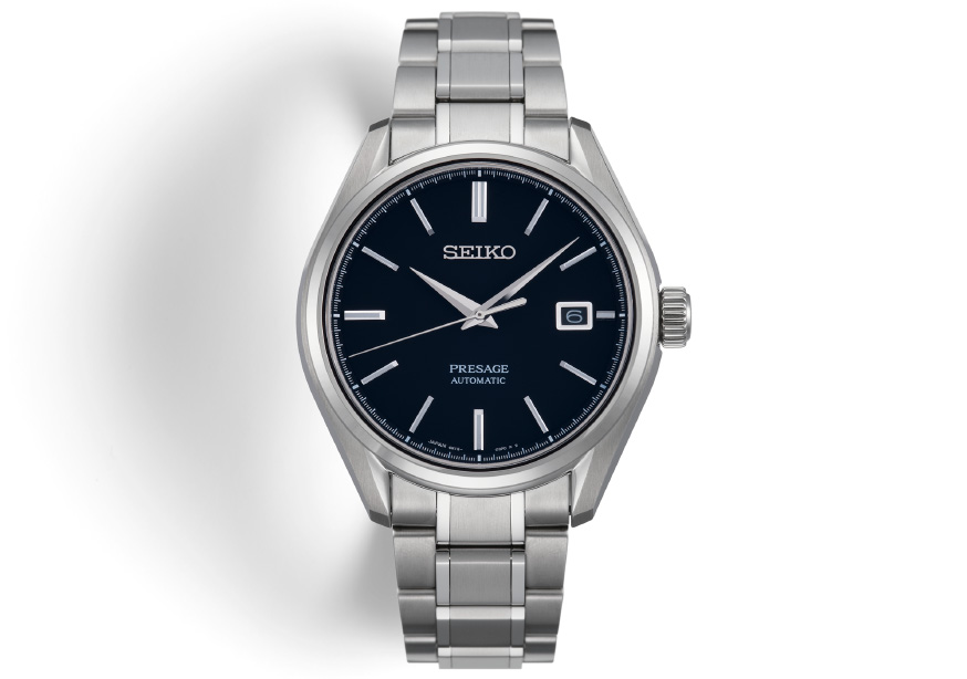 Front view of the Presage SARX057. Black dial, round shape