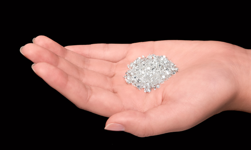 Photo of a bunch of diamonds on a hand