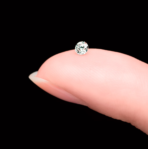 Photo of a single diamond on a fingertip