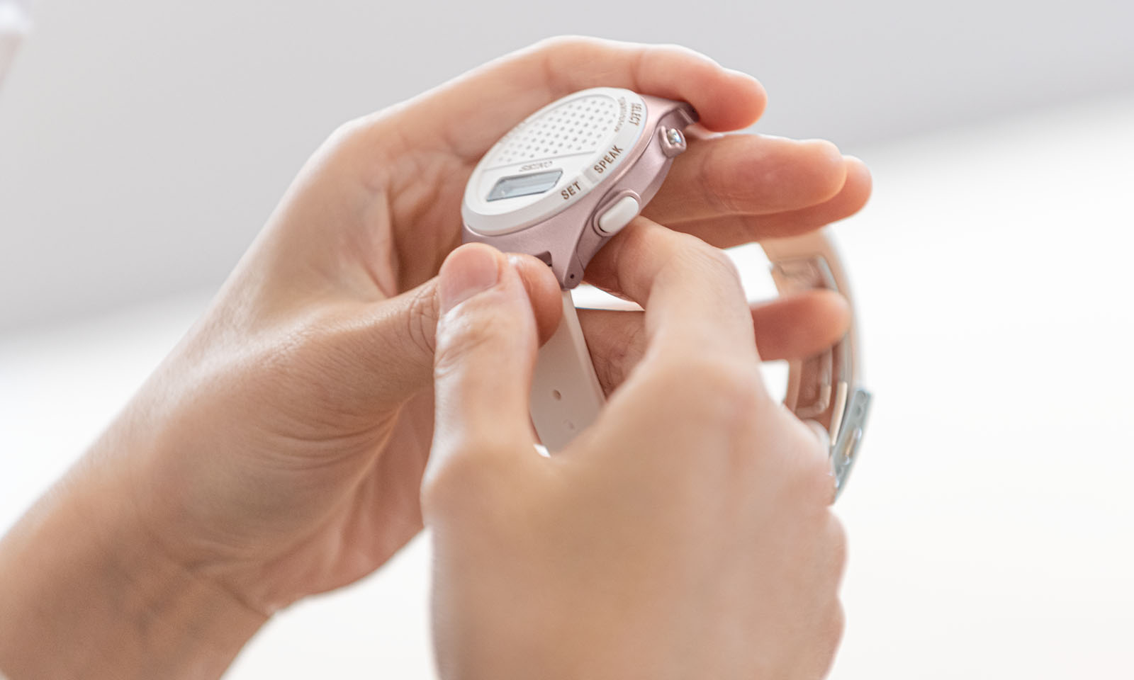 Photo of Ms. Takada holding a digital talking watch